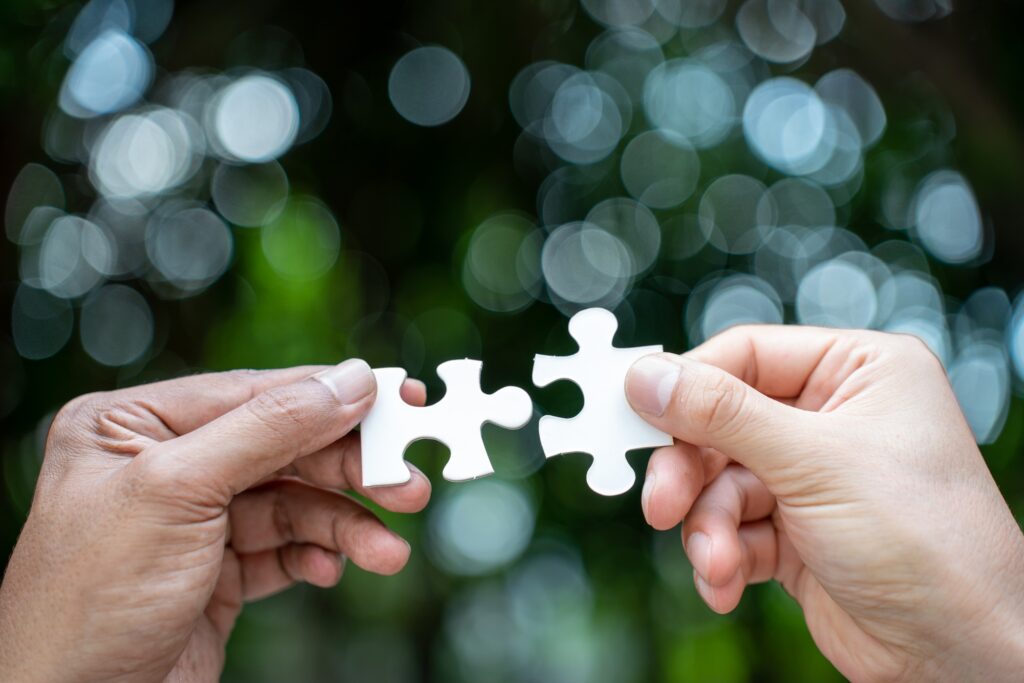 team hand power full hand placing the jigsaw puzzle piece for conect business partner and connection