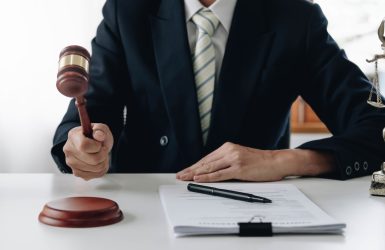 Lawyer or judge holding Hammer prepares to judge the case with justice, and litigation, scales of justice, law hammer, Legal consulting services, Concept of litigation, and legal services..